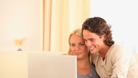 Happy Couple Enjoying Leisure Time Browsing at Home