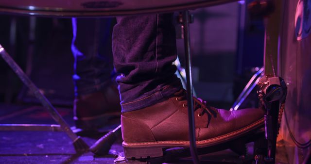 Foot of drummer on bass drum pedal playing drums at band practice, copy space. Music, practice, creativity and lifestyle, unaltered.
