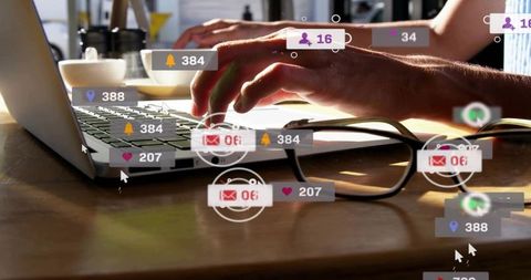 Typing hands on laptop with floating social notifications over warm wooden workspace