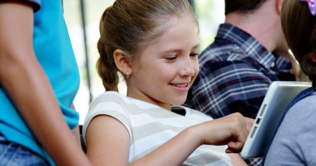 Smiling Girl Using Tablet with Family at Home - Download Free Stock Images Pikwizard.com