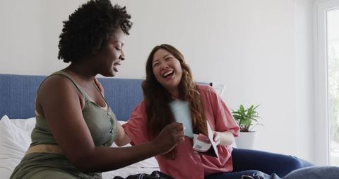 Diverse friends laughing together sharing travel plans