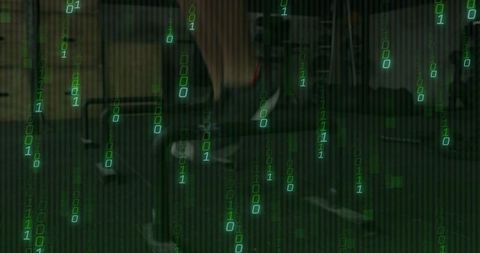 Cybersecurity workstation with falling green binary code overlay and programmer at desk
