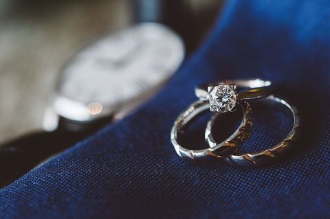 Elegant diamond engagement rings on blue fabric