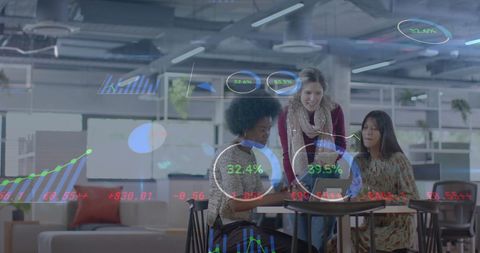 Businesswomen analyzing financial data in modern office