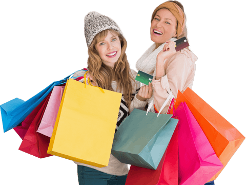 Two women holding shopping bags smiling transparent background