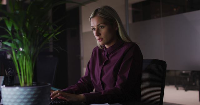 Female Office Worker Working Late at Night in Dimly Lit Office - Download Free Stock Images Pikwizard.com