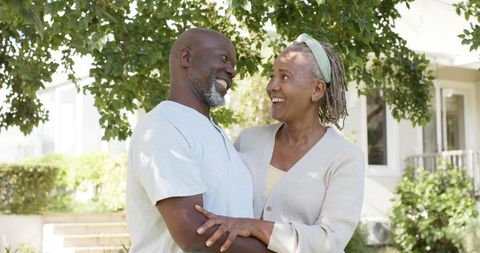 Joyful Senior Couple Embracing Outdoors in Sunny Garden - Download Free Stock Images Pikwizard.com