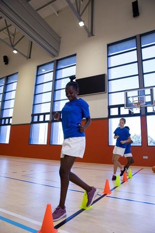Teenage Female Athletes Training on Gymnasium Court