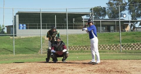 Baseball players in action at home plate