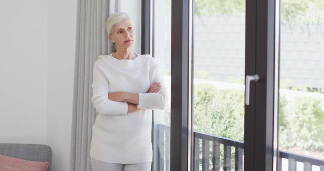 Image of thoughtful caucasian senior woman looking outside window - Download Free Stock Photos Pikwizard.com