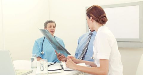 Doctors Analyzing X-Ray in Collaborative Medical Meeting - Download Free Stock Images Pikwizard.com