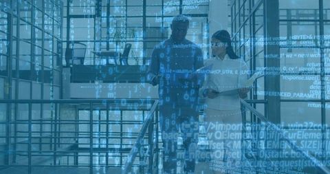 Two Coworkers Collaborating on Tablet While Walking Staircase with Digital Code Overlay