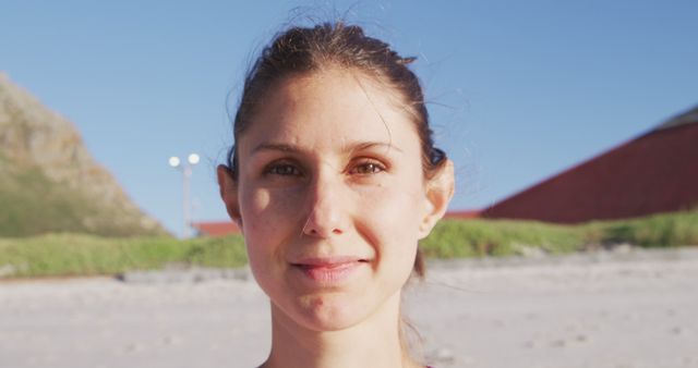 Woman Enjoying Sunny Day at Beach Looking at Camera - Download Free Stock Images Pikwizard.com