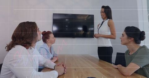Female Leader Presenting to Team in Modern Boardroom with Data Visualization Overlay