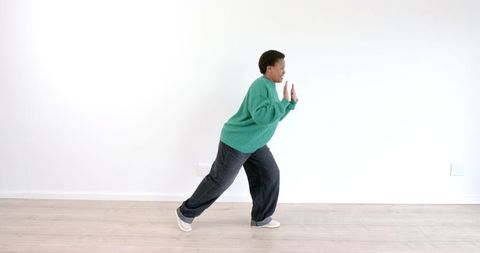 Individual Dancing Energetically in Spacious Living Room