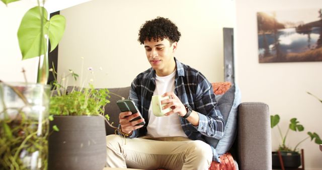 Man Drinking Coffee and Using Smartphone in Cozy Living Room - Download Free Stock Images Pikwizard.com