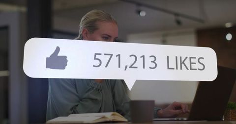 Professional Woman Engaging with Social Media Metrics on Laptop