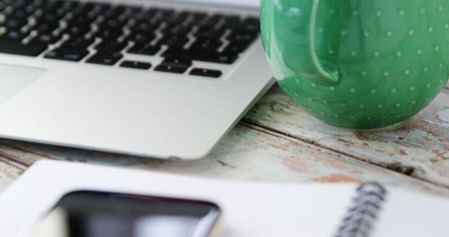 Laptop, Green Coffee Mug, and Smartphone on Rustic Desk - Download Free Stock Images Pikwizard.com