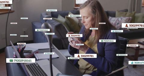 Senior Woman Engaging with Smartphone Messages at Home Desk