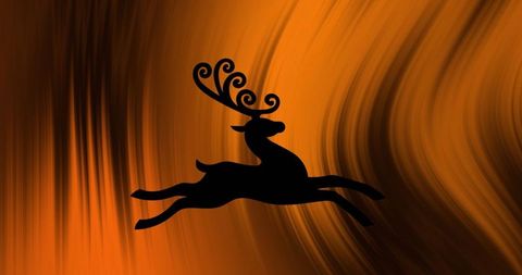 Silhouette of a leaping deer on abstract orange background