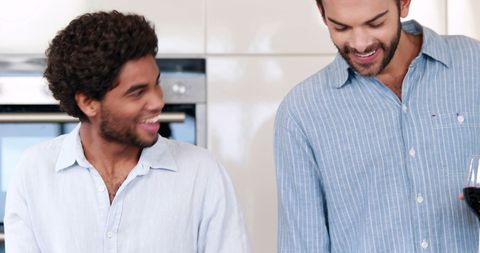 Friends Enjoying Relaxed Moment with Wine in Kitchen