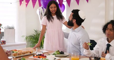 Family celebrating with traditional meal at home ceremony