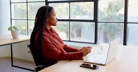 Confident Woman Working on Laptop in Bright Office Environment - Download Free Stock Images Pikwizard.com