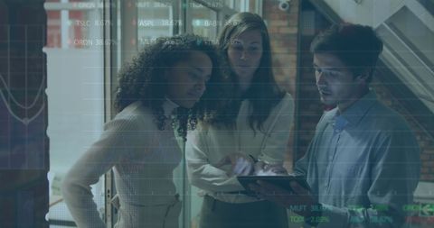 Multicultural Team Analyzing Digital Financial Data in Office Setting