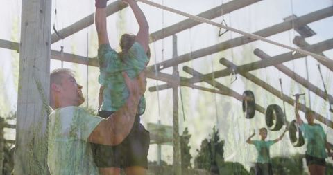 Father Supporting Daughter on Outdoor Adventure Challenge Course