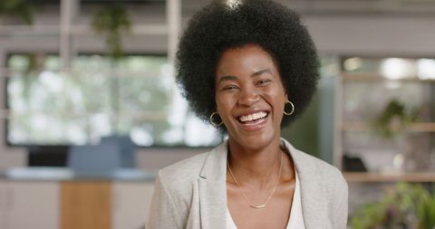 Confident African American Woman Smiling in Modern Office