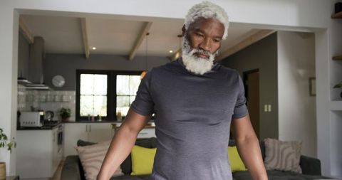 Contemplative Senior Man at Home in Modern Living Space