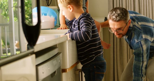 Father and Son Bonding in Modern Kitchen - Download Free Stock Images Pikwizard.com