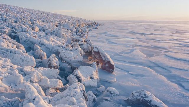 Majestic arctic landscape with snow-covered rocks and frozen sea