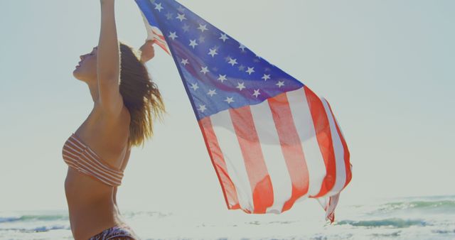 Woman Celebrating Freedom with American Flag at Beach - Download Free Stock Images Pikwizard.com