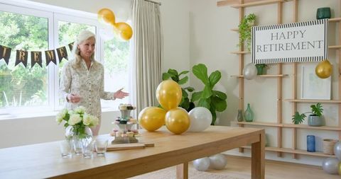 Senior woman planning retirement party with decorations