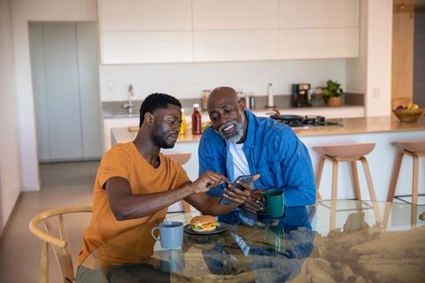 Father and Son Sharing Moment in Modern Kitchen over Breakfast