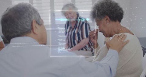 Caregiver comforting tearful older woman wiping tears with tissue placing hand on shoulder