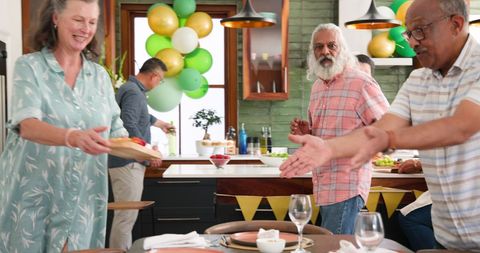 Senior friends preparing dinner party at home celebration