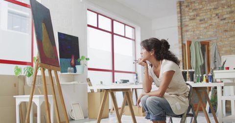 Artist in Thoughtful Creativity Gazes at Canvas in Bright Studio - Download Free Stock Images Pikwizard.com