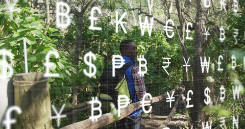 Hiker Exploring Trails Overlaid with Global Currency Symbols