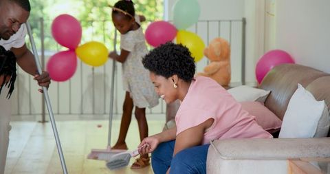 Family Teamwork Cleaning Up After Downsized Home Party