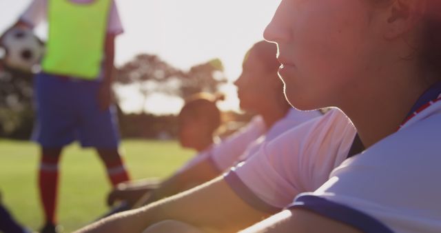 Focused Youth Soccer Players Sitting on Field Under Sunlight - Download Free Stock Images Pikwizard.com