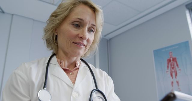 Female Doctor Smiling and Using Smartphone in Medical Office - Download Free Stock Images Pikwizard.com