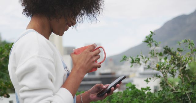 Woman Enjoying Coffee and Using Smartphone Outdoors - Download Free Stock Images Pikwizard.com