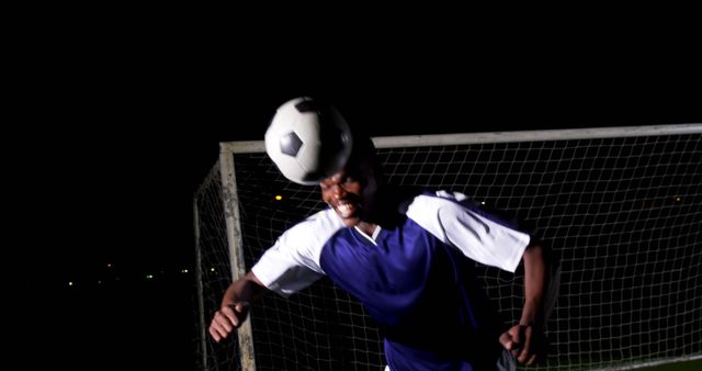 Male Soccer Player Heading Ball During Night Game - Download Free Stock Images Pikwizard.com