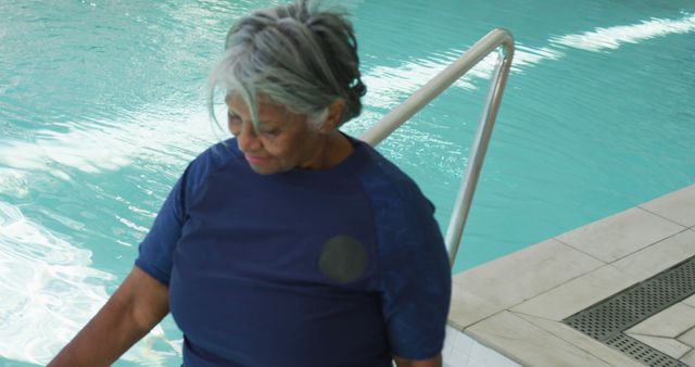 Senior woman on poolside in casual outfit. Useful for promoting leisure activities for seniors, lifestyle content for older adults, wellness programs, and community events. Ideal for health and fitness articles or websites focused on senior citizens.