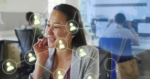 Asian Businesswoman Engaging in Global Networking with Phone Headset