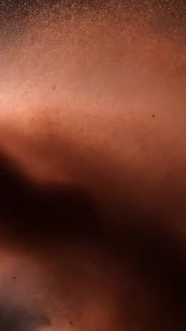 Swirling Ember Dust Cloud Rising from Eruption with Rock Fragments in Dark Void - Vertical Video