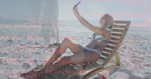 Woman Relaxing on Beach With Overlaying Financial Data Concept