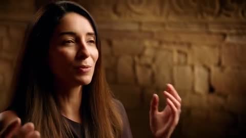 Woman Sharing Story While Gesturing in Warm Soft Closeup Studio Interview with Textured Stone Wall